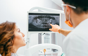 Dentist and patient looking at x-rays